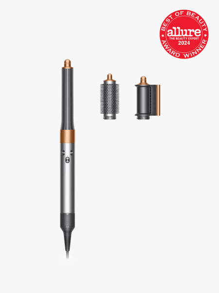 Dyson Airwrap Origin in branded components on a light gray background with best of beauty seal in the top right corner